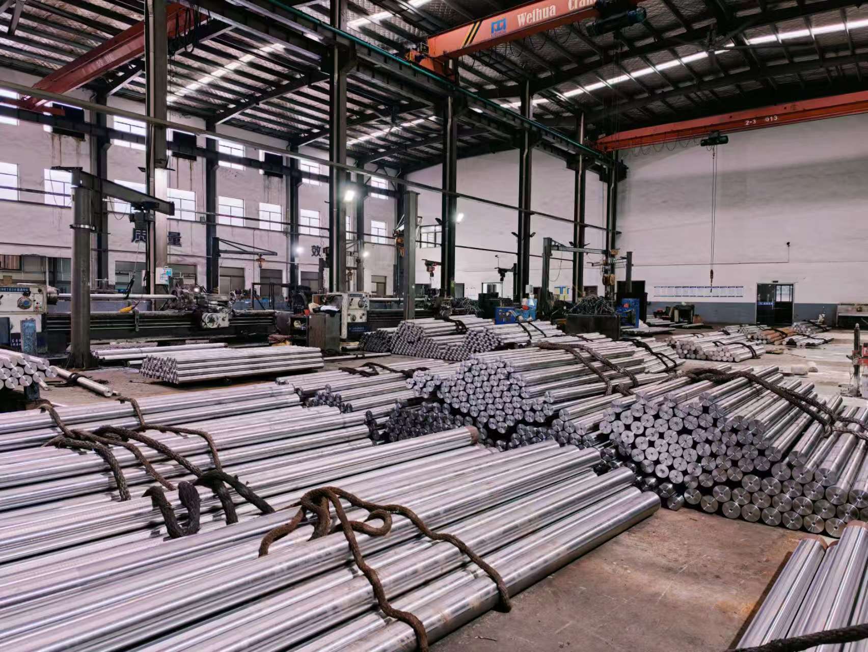 Bundles of steel bars and shafts inside the machining workshop